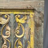 Rectangular Indonesian construction element with blue and yellow plant in carved wood