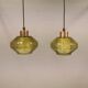 Hanging lamp with an outer shade of olive green glass and an inner shade of clear, crystal glass.