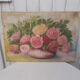 Tableau of a bouquet of flowers on a double-sided wooden panel.