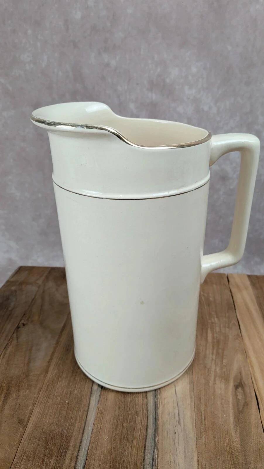 Large antique jug from Sarreguemines with golden trim.