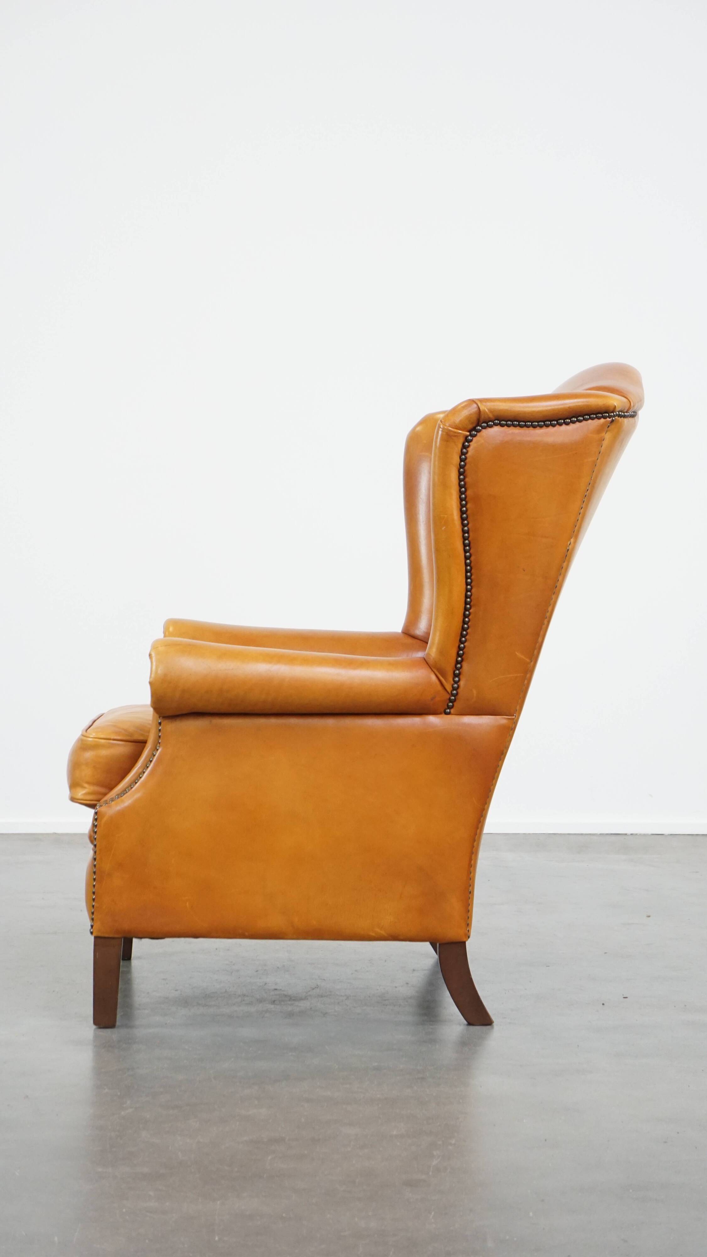 Cow leather wingback chair finished with decorative nails