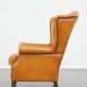 Cow leather wingback chair finished with decorative nails