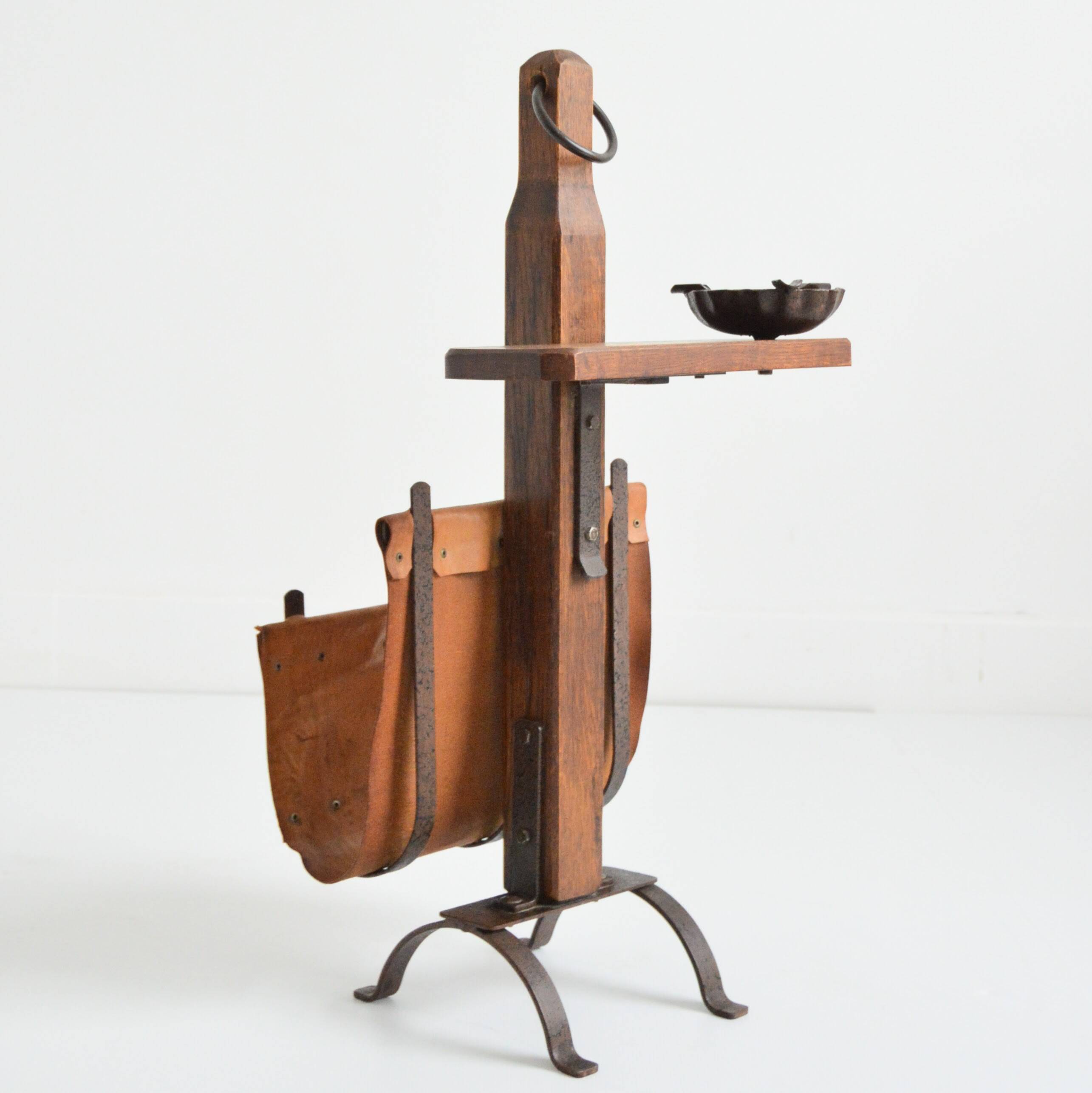 Vintage leather magazine rack with shelf and brutalist/rustic ashtray.