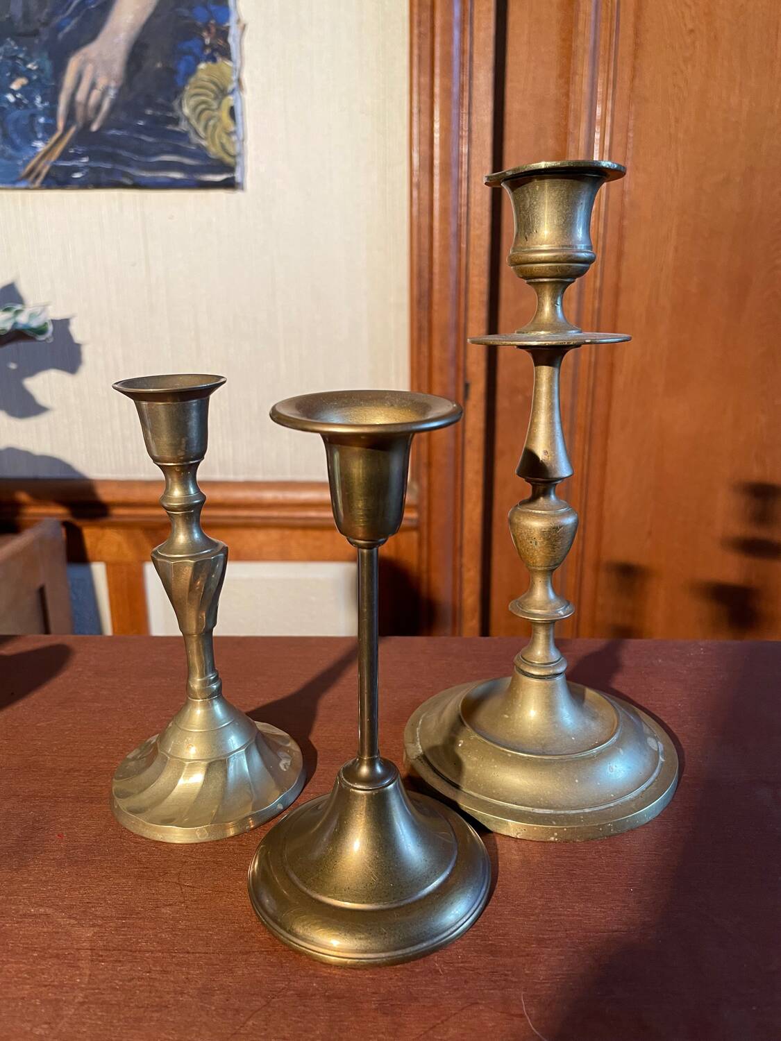 Trio of brass candlesticks