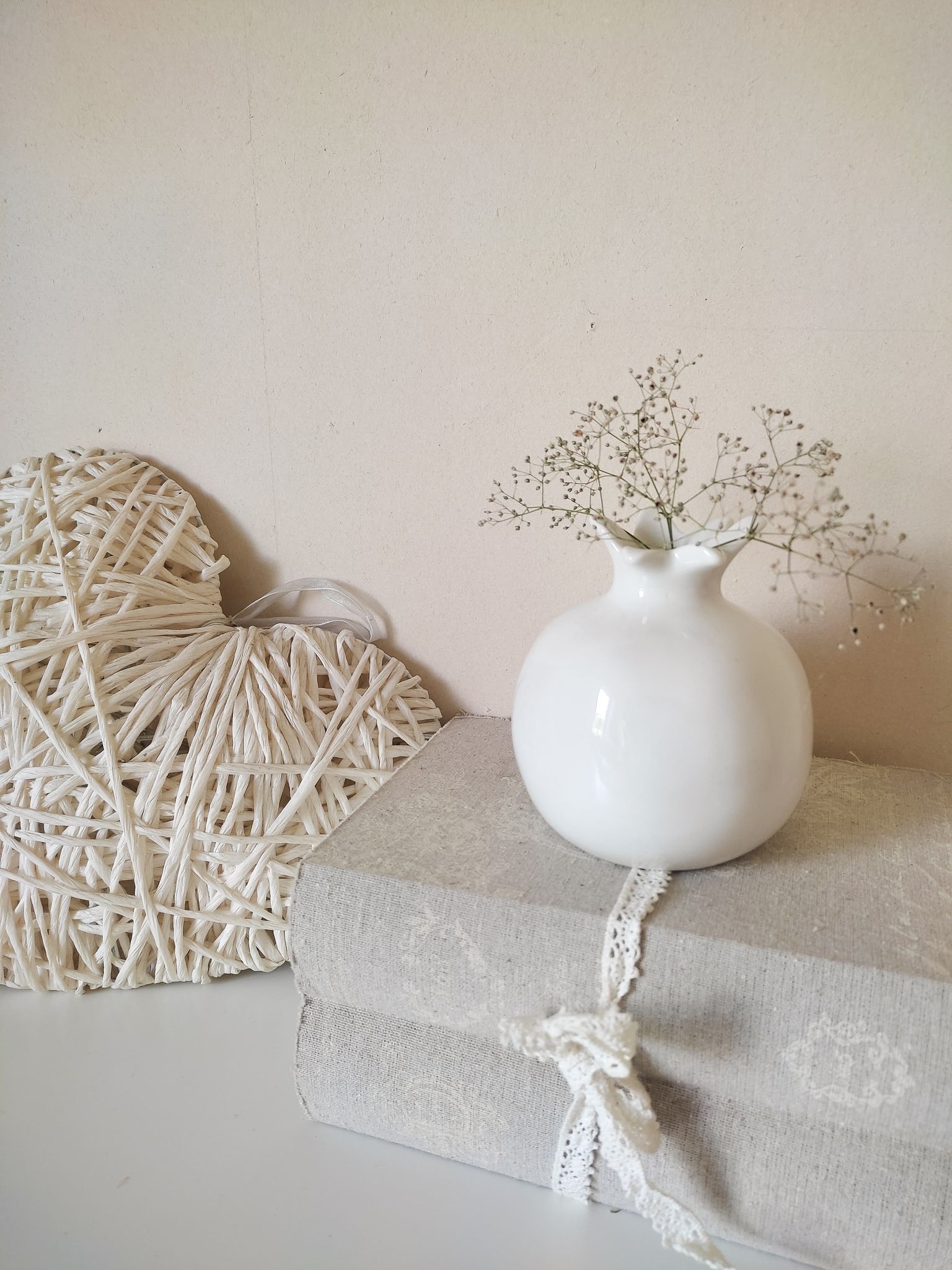 White ceramic vase in the shape of a pomegranate