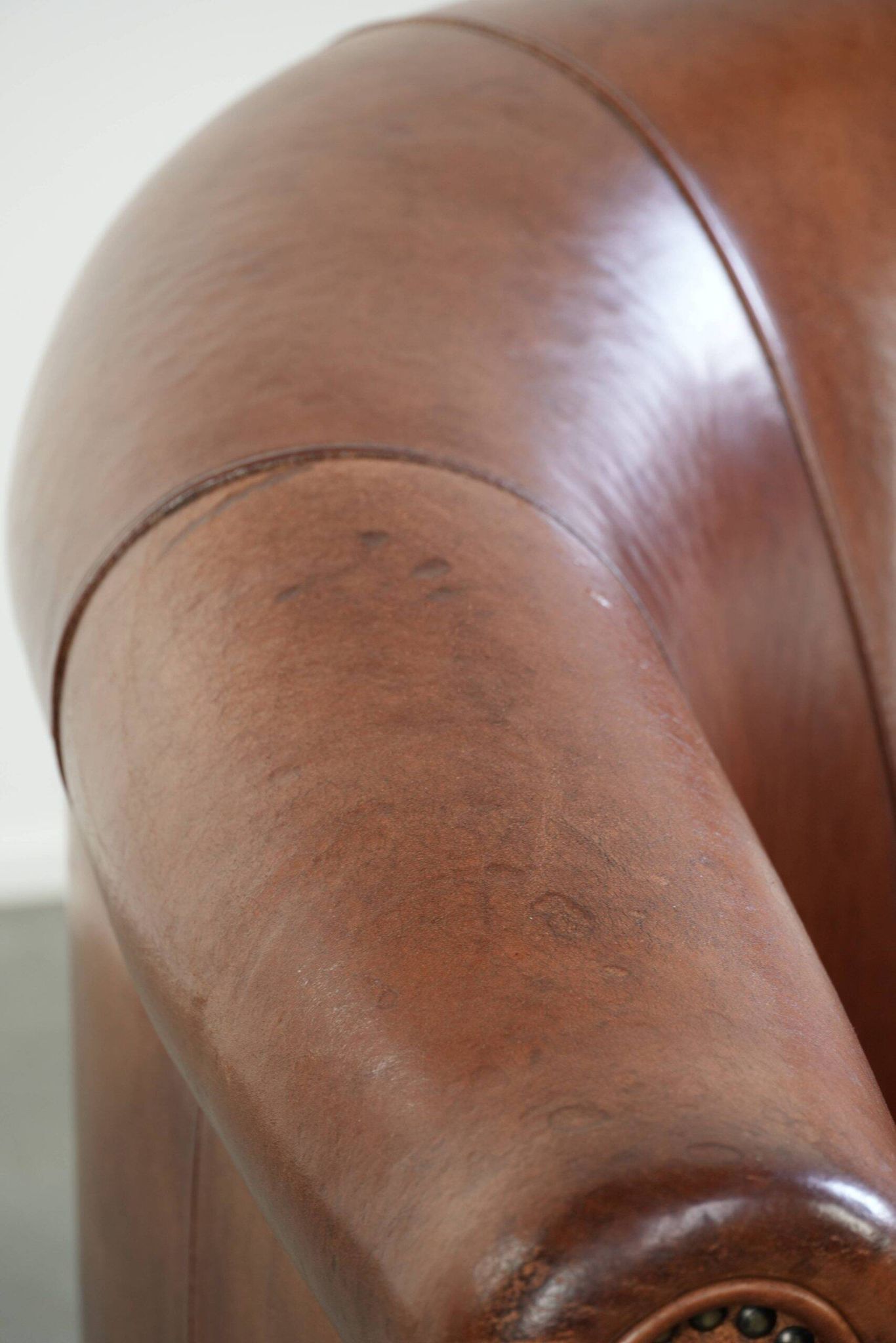 Vintage sheepskin club armchair in English style with deep colours