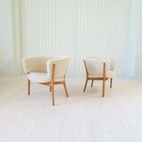 Mid-century lounge chairs in sheepskin/shearling and stained wood, Sweden, 1962.