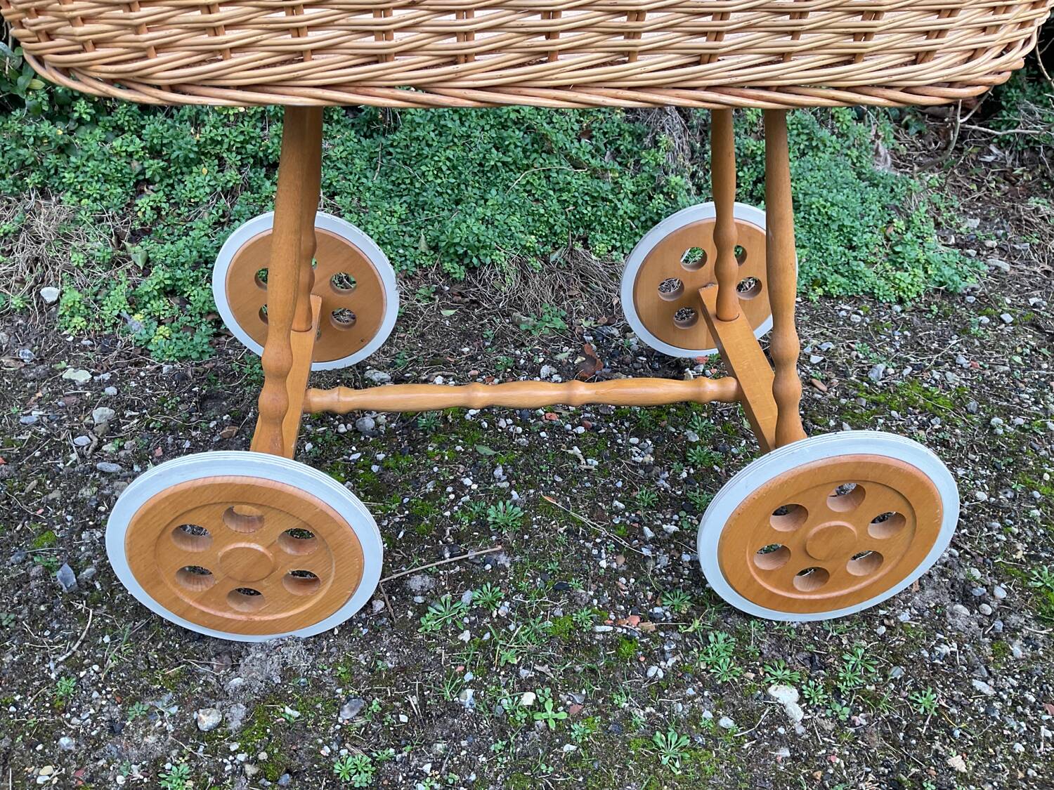 Vintage wicker cradle on casters