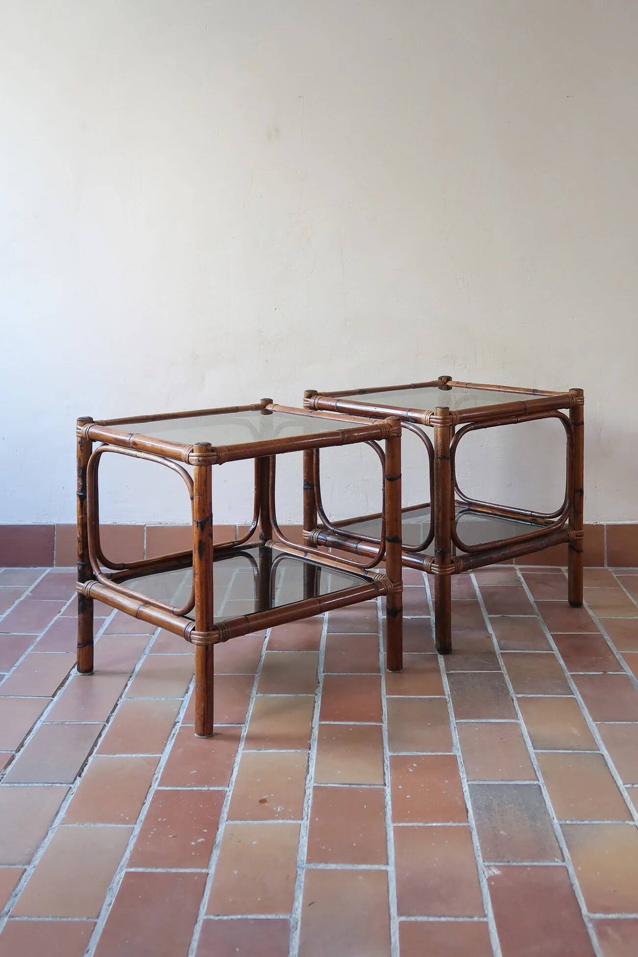 Pair of bamboo and rattan bedside tables, smoked glass tops.