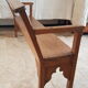 Church bench in fir tree with armrests