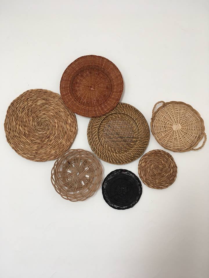 Wall composition of seven baskets and wicker trays