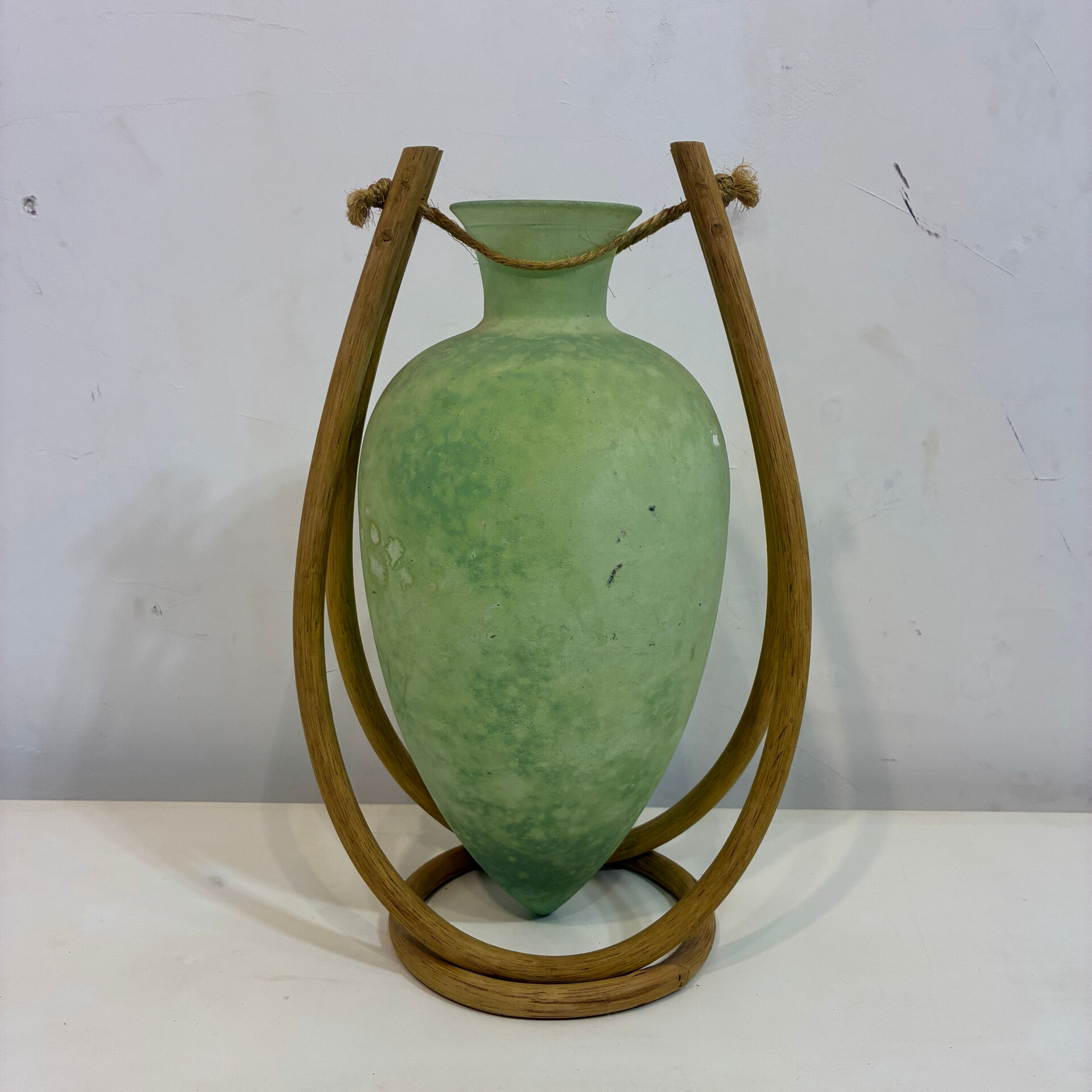 Rare glass paste amphora suspended in a wicker frame.