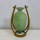 Rare glass paste amphora suspended in a wicker frame.