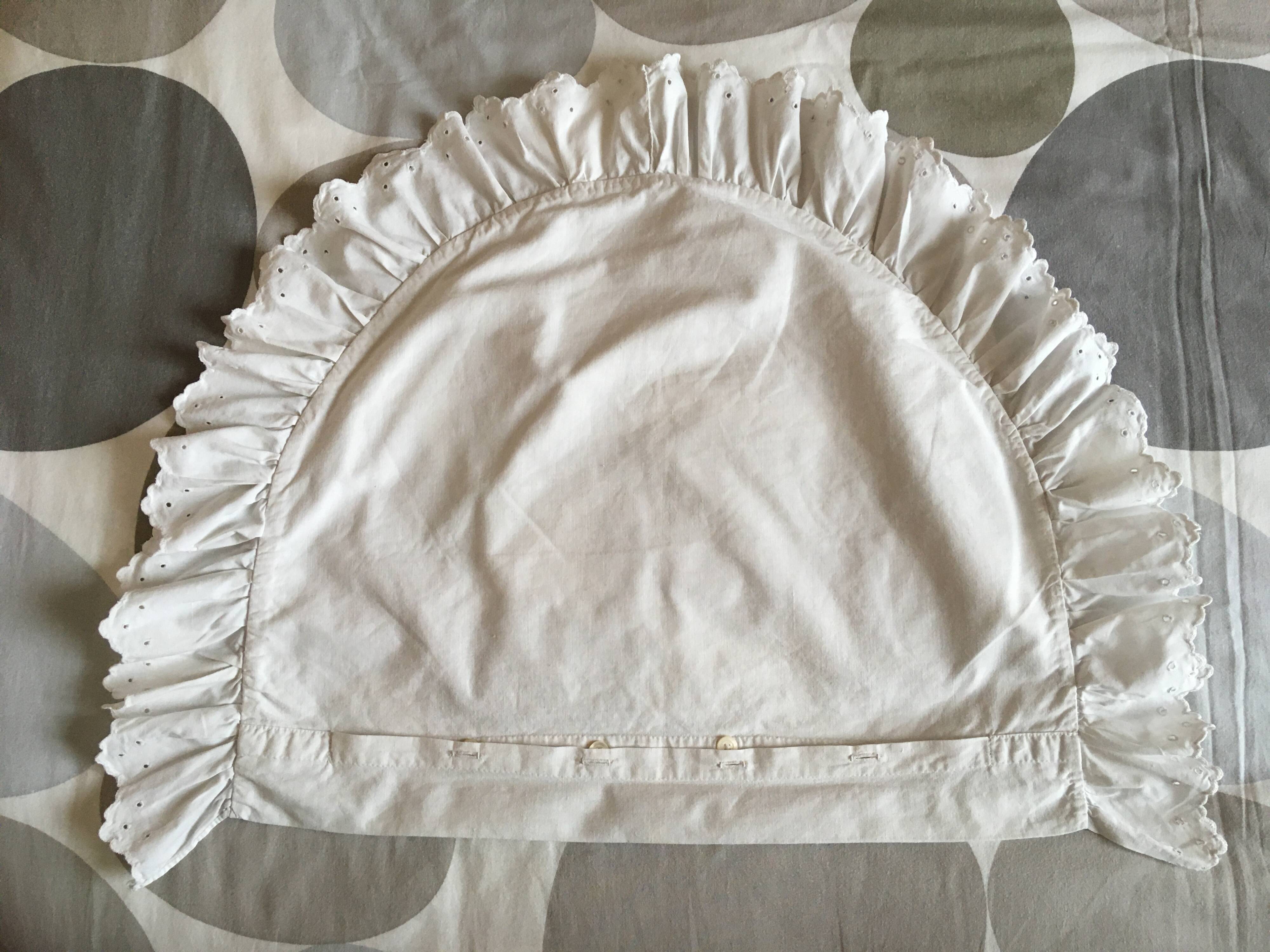 Two half-moon ruffled cushion covers