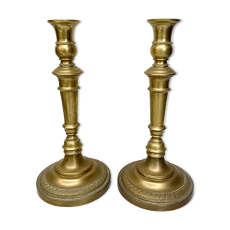 Pair of old candle holders in golden brass