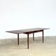 Rosewood dining table with integrated extensions — Denmark, 1960s