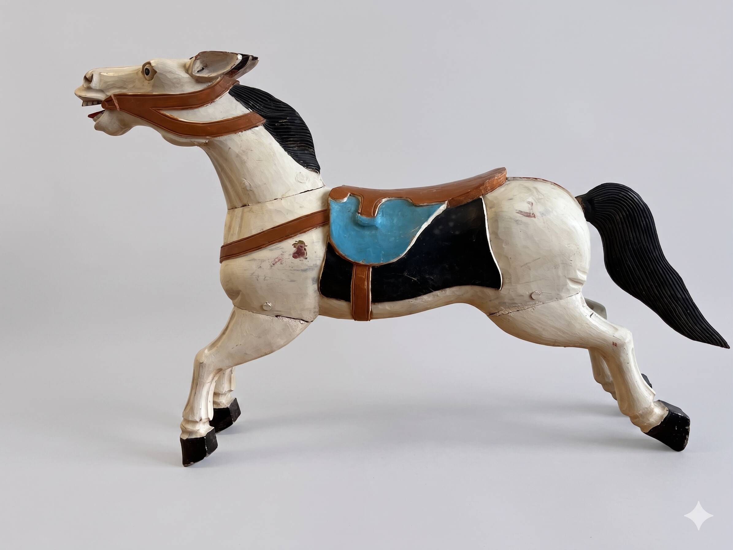 Pair of large hand-painted Indonesian horses with saddle