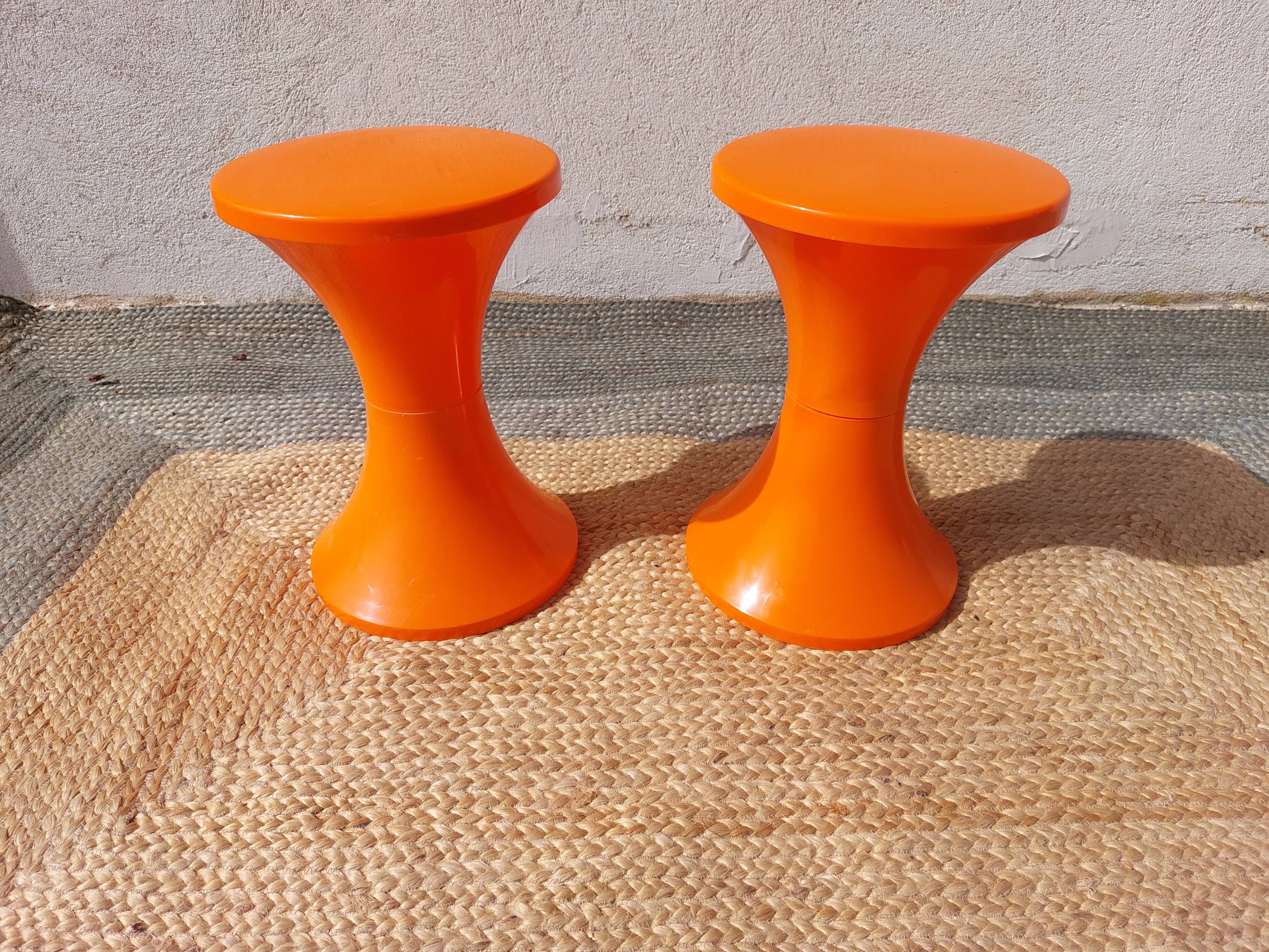 pair of orange tam-tam stools