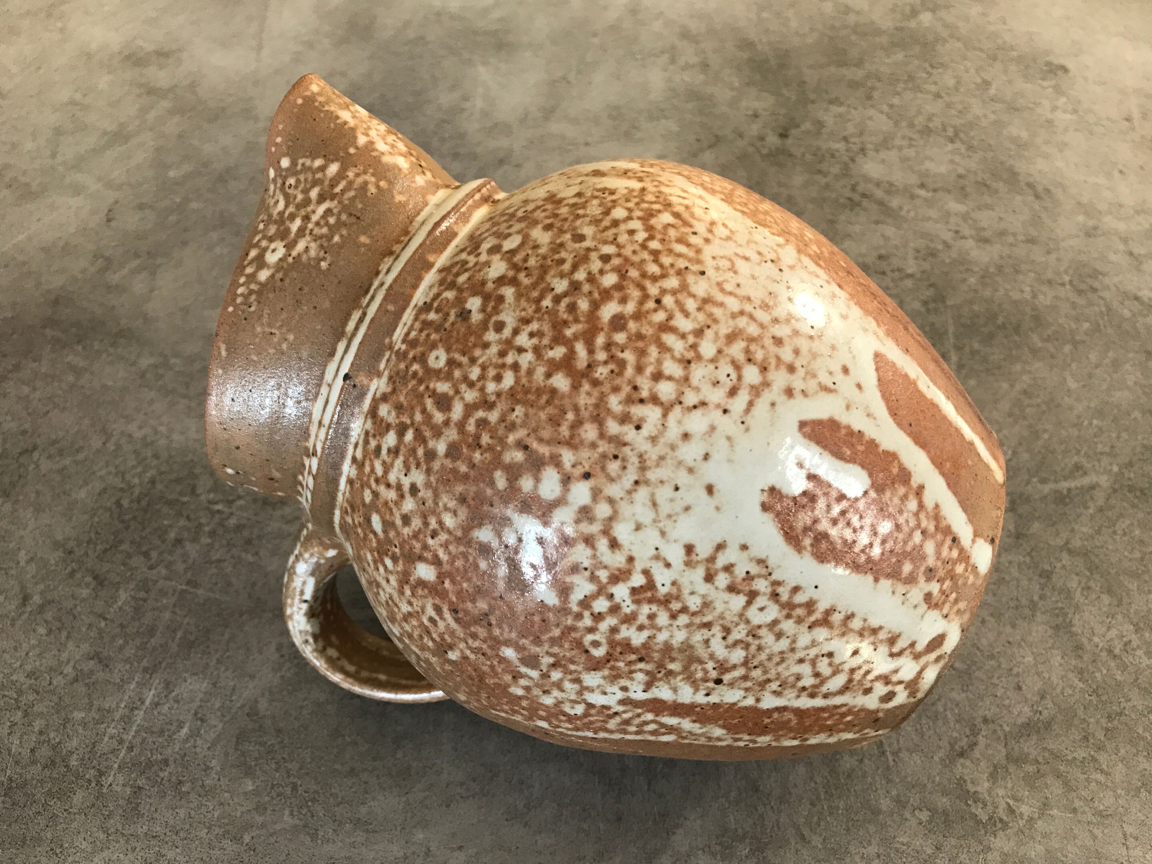 Pitcher in brown sandstone with effect of dripping and white speckling