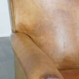 Stylish patinated vintage sheepskin armchair with a comfortable seat