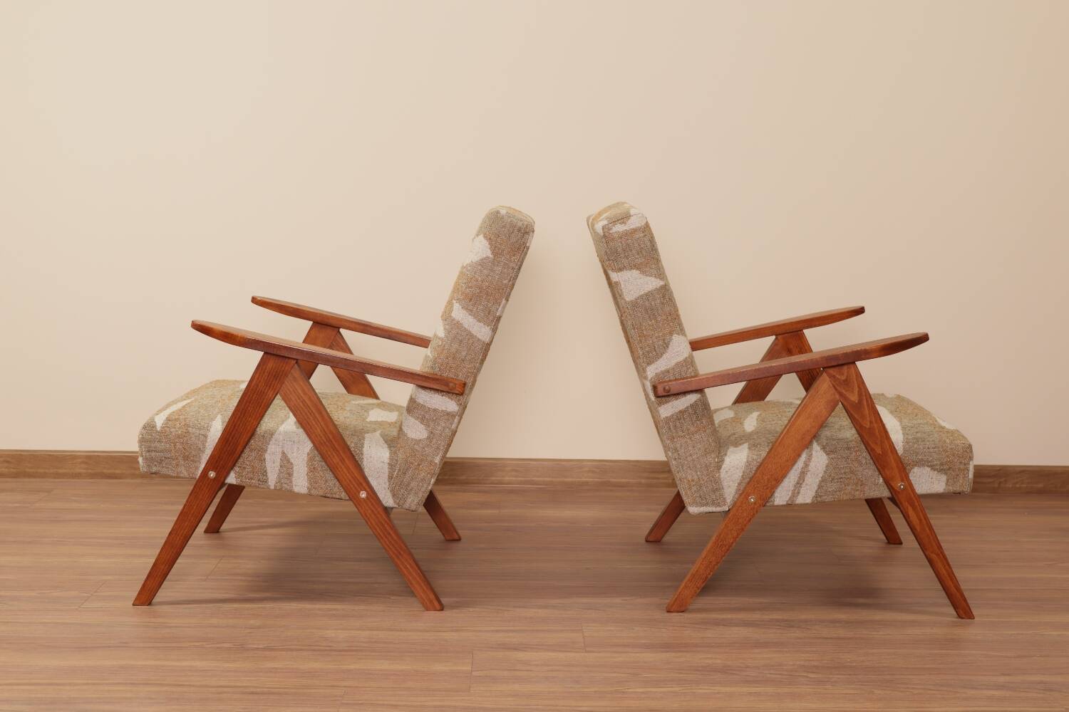 Pair of vintage lounge chairs in brown jacquard fabric and wood.