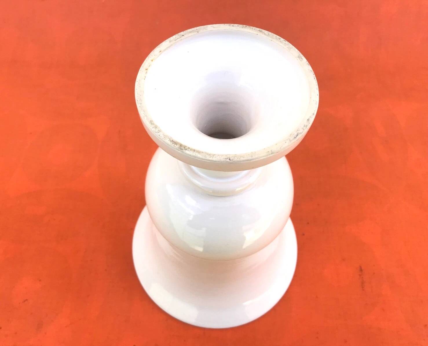 Vase on a pedestal, glazed white ceramic.