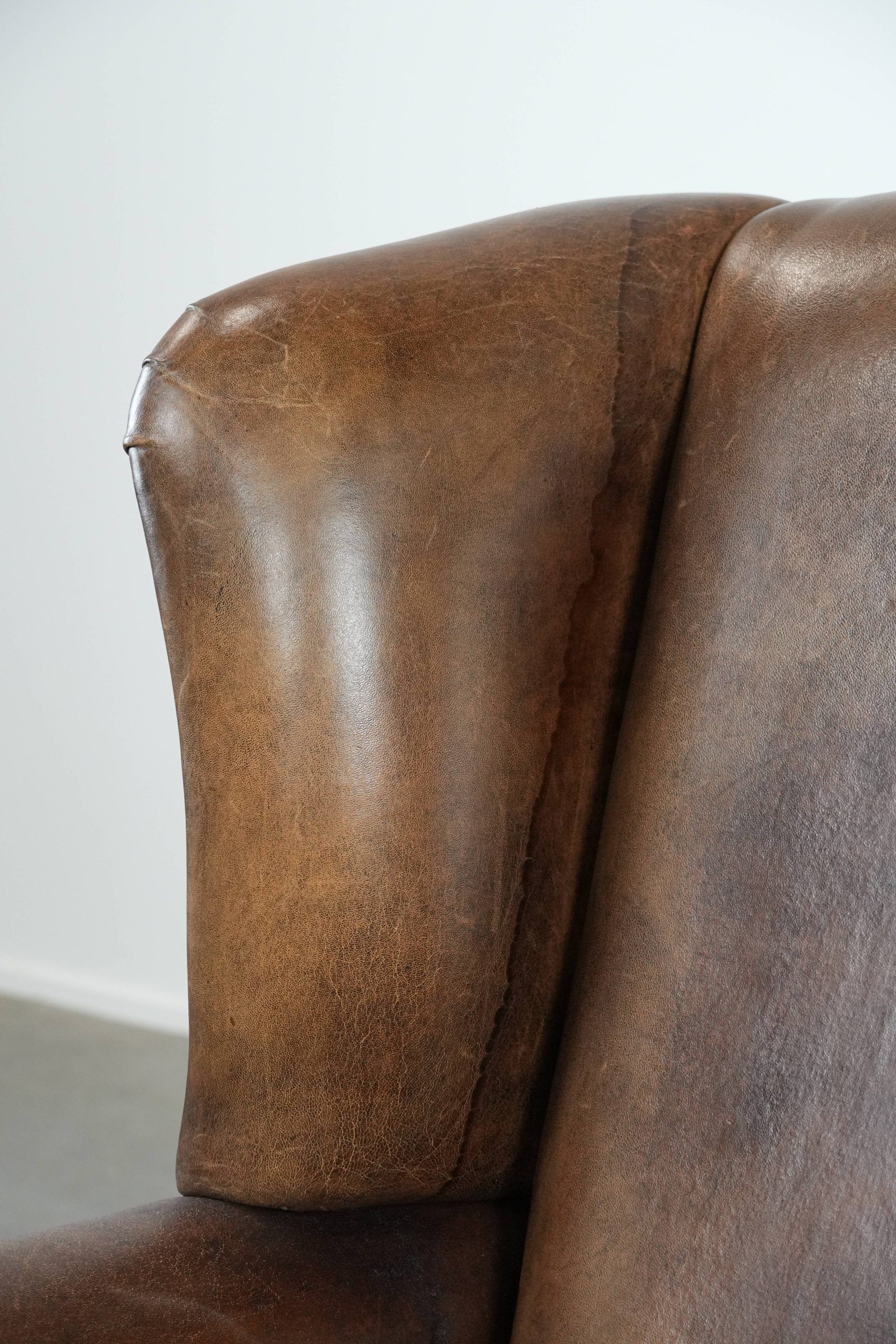 Warm, cosy and comfortable vintage sheepskin ear armchair with character