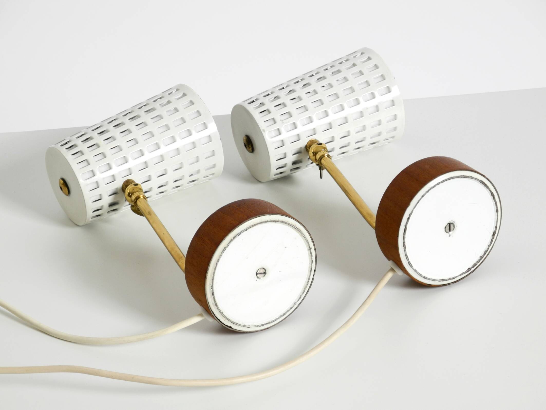 A pair of mid-century modern bedside lamps with perforated metal shades