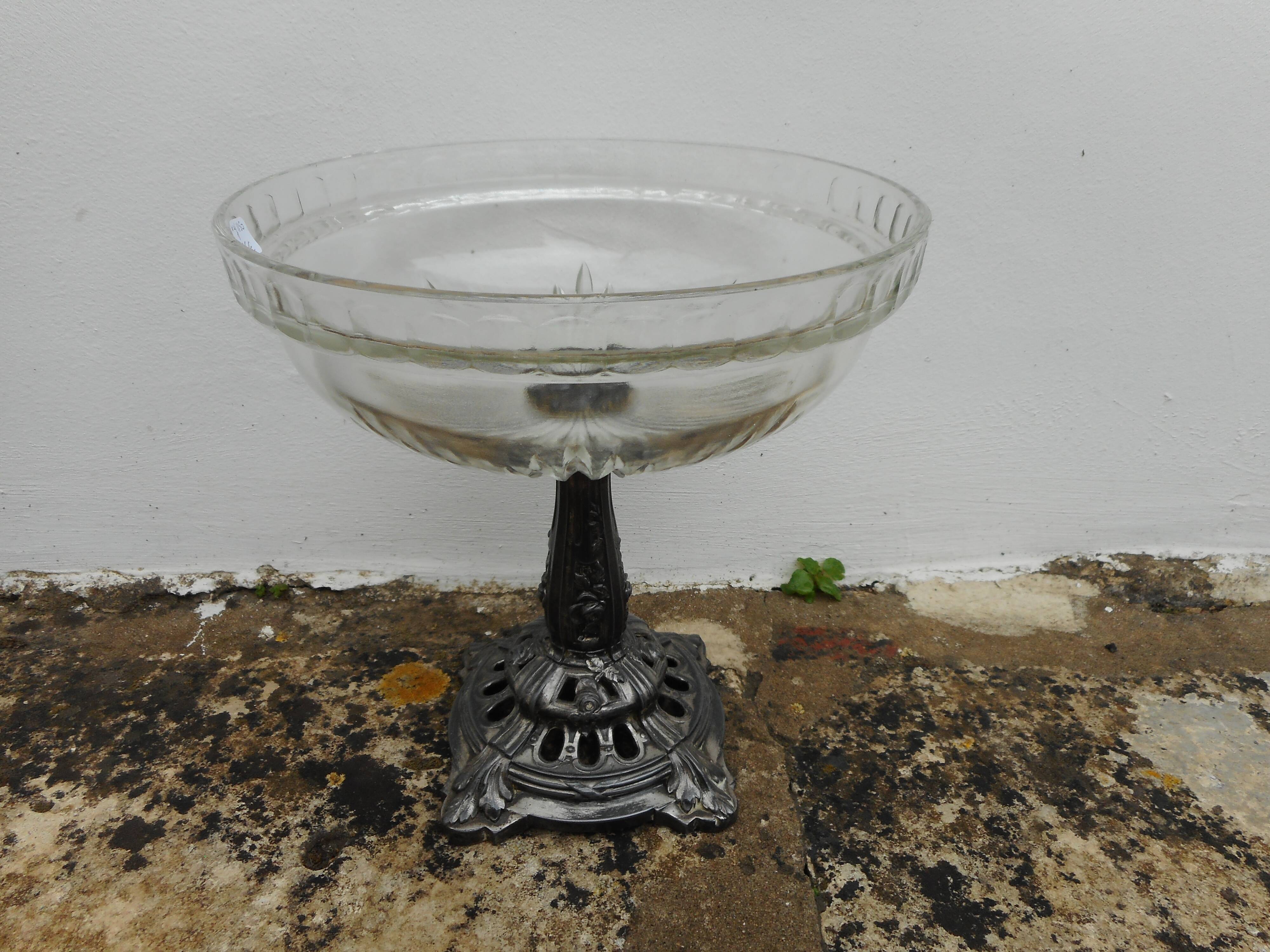 A glass cup on metal stand