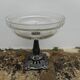A glass cup on metal stand