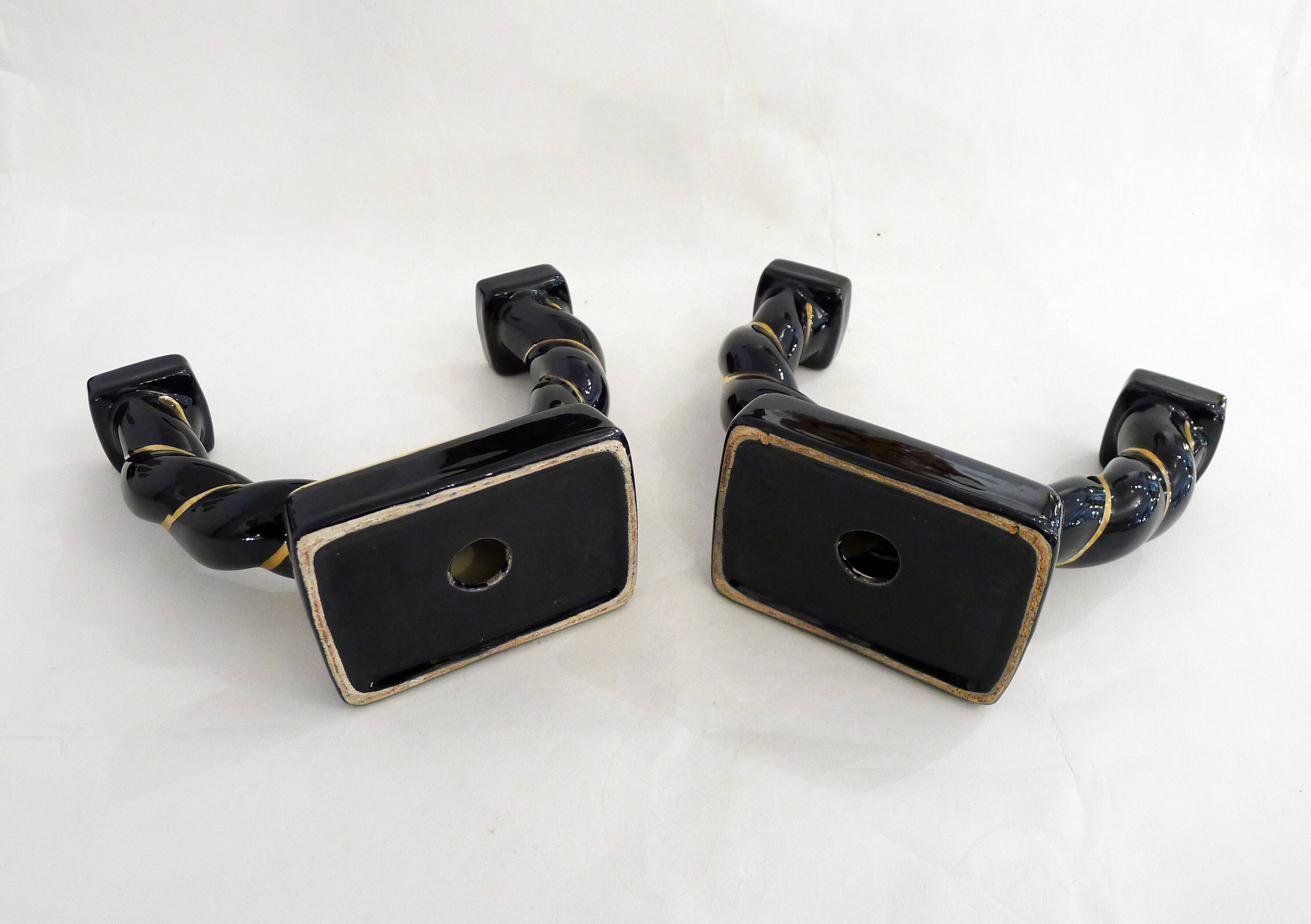 Pair of earthenware braided rope candlesticks