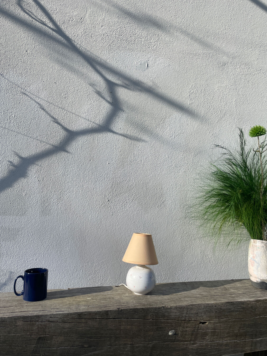 Small cracked white ceramic lamp with flowers.