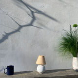 Small cracked white ceramic lamp with flowers.