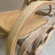 Rocking chair with a cane seat and backrest.