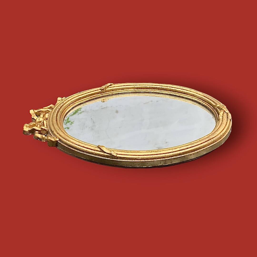 Antique oval mirror in gilded resin with Louis XVI style knot decoration