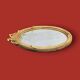 Antique oval mirror in gilded resin with Louis XVI style knot decoration