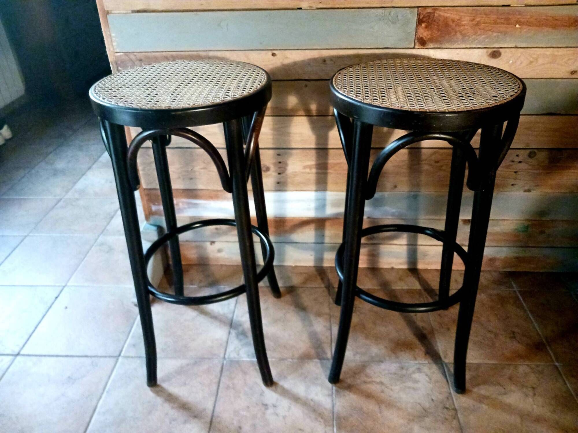 Set of 2 high bar stools made of wicker and rattan cane.