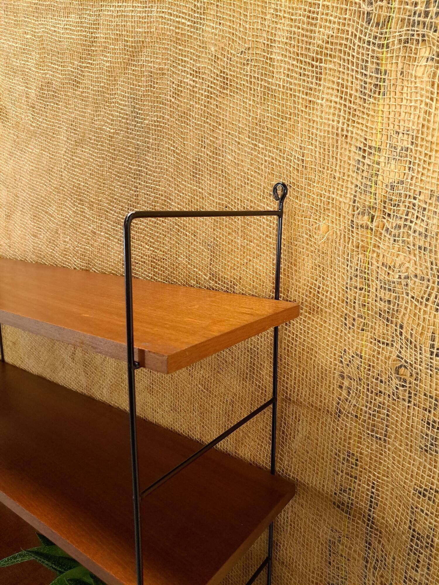 Wall rack with shelves and steel holders, dark wall system