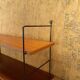 Wall rack with shelves and steel holders, dark wall system
