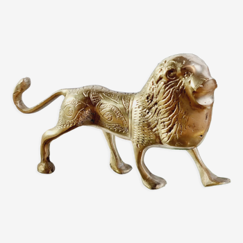Lion in chiseled gilded brass