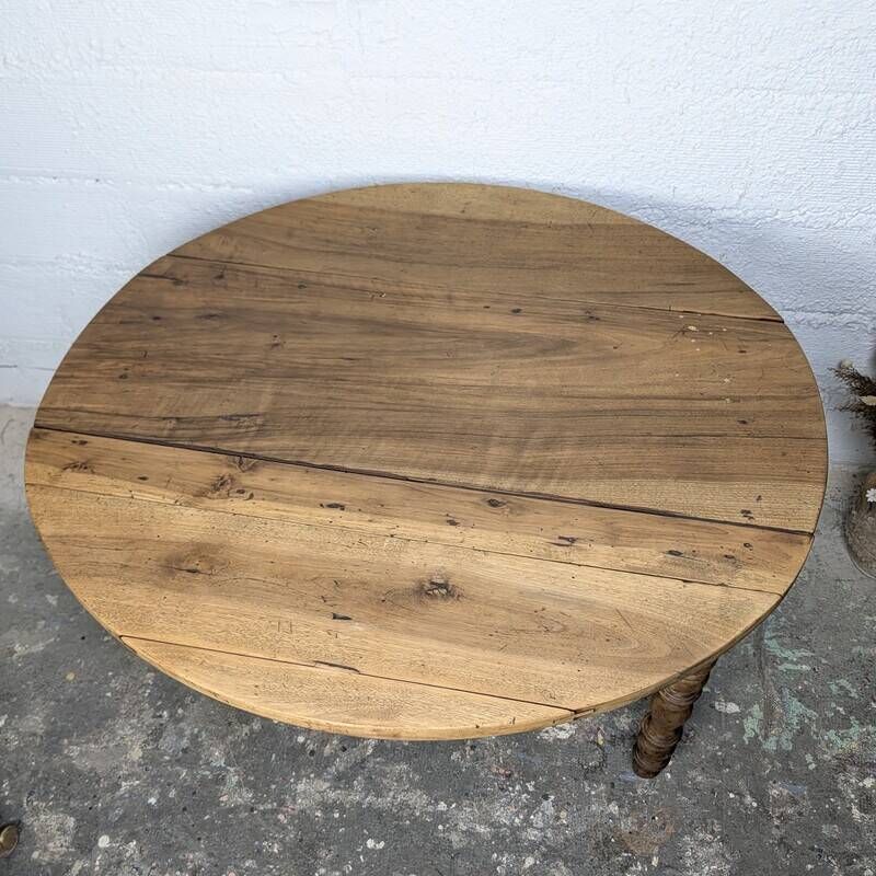 Antique wooden drop-leaf table with turned legs.