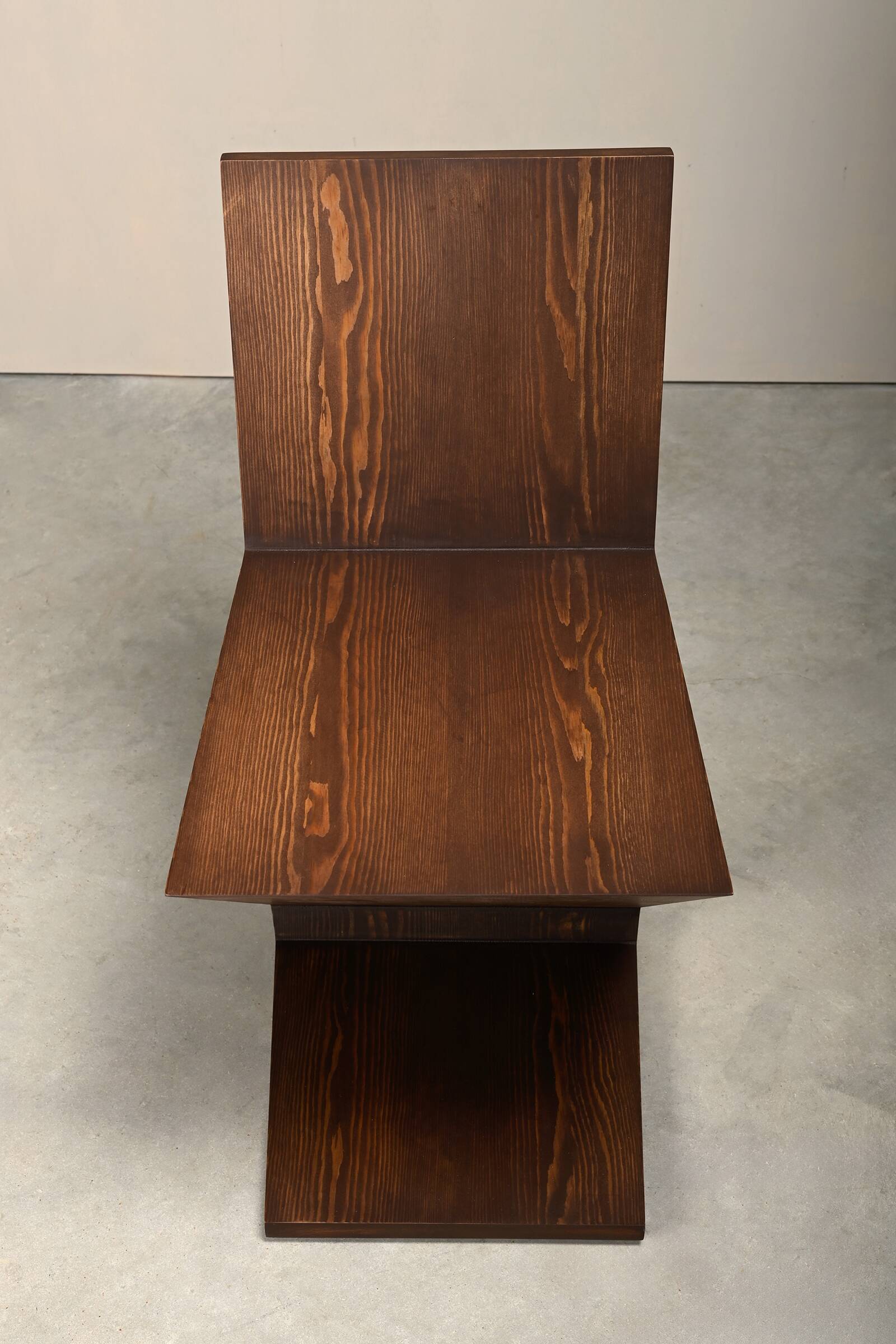 Gerrit Rietveld Zig Zag Chair is dark brown stained wood