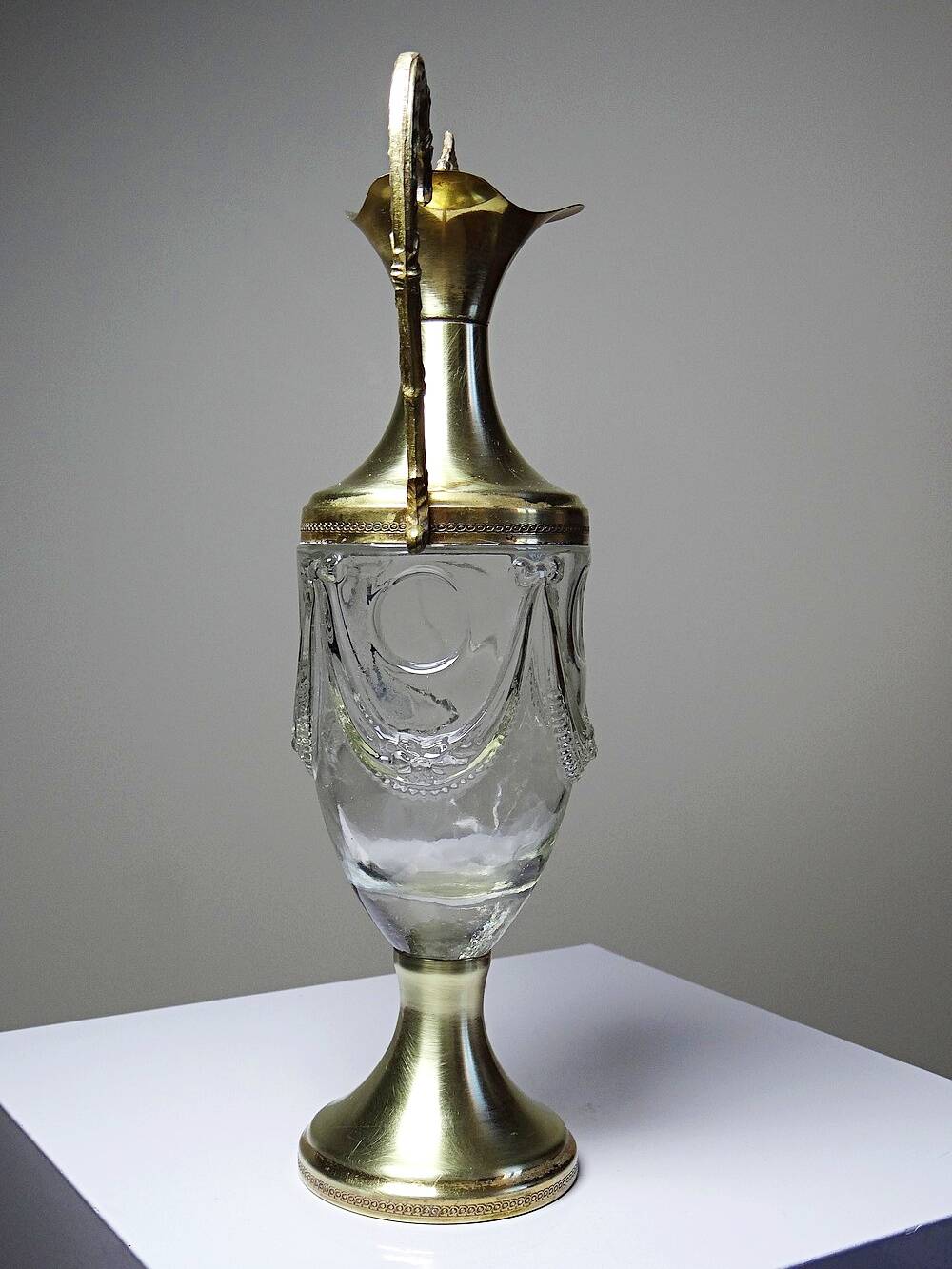 Vintage decorative jug in moulded glass and gilded brass, Italy circa 1980.