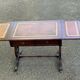 Victorian English extendable coffee table made of solid mahogany and leather.