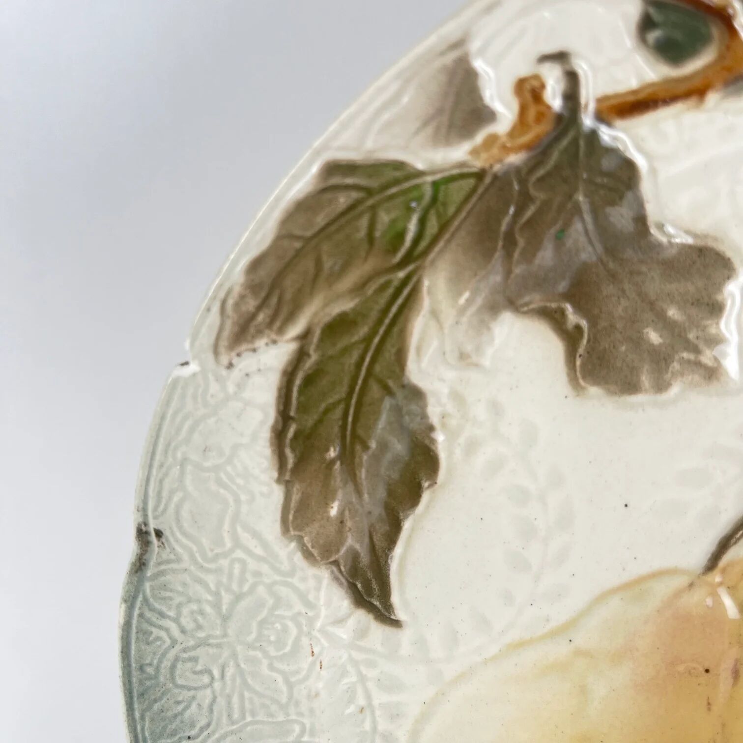 Set of 4 plates KG St Clément barbotine fruit (cherry, mirabelle, grape, pear), late 19th-early 20th century.