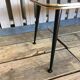 Vintage black and gold glass coffee table with conical legs from the 1940s.