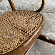 Warm walnut bentwood and cane child's rocking chair early 20th-century