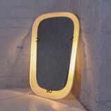 Luminous mirror in perforated sheet metal and brass