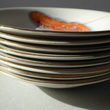 Eight hollow plates decorated with lobsters