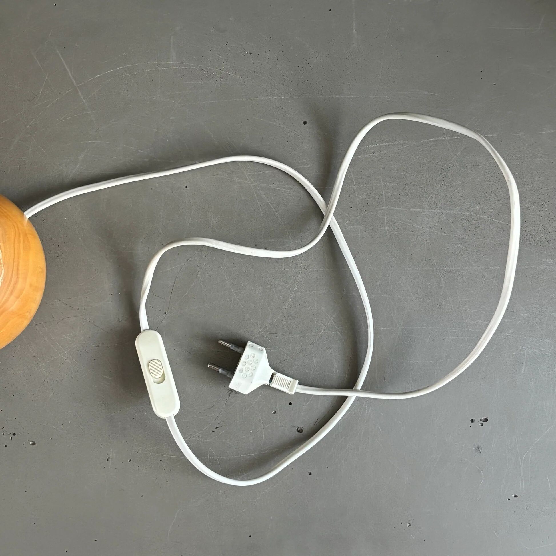 Three wooden ball-shaped lamp stands in light wood.